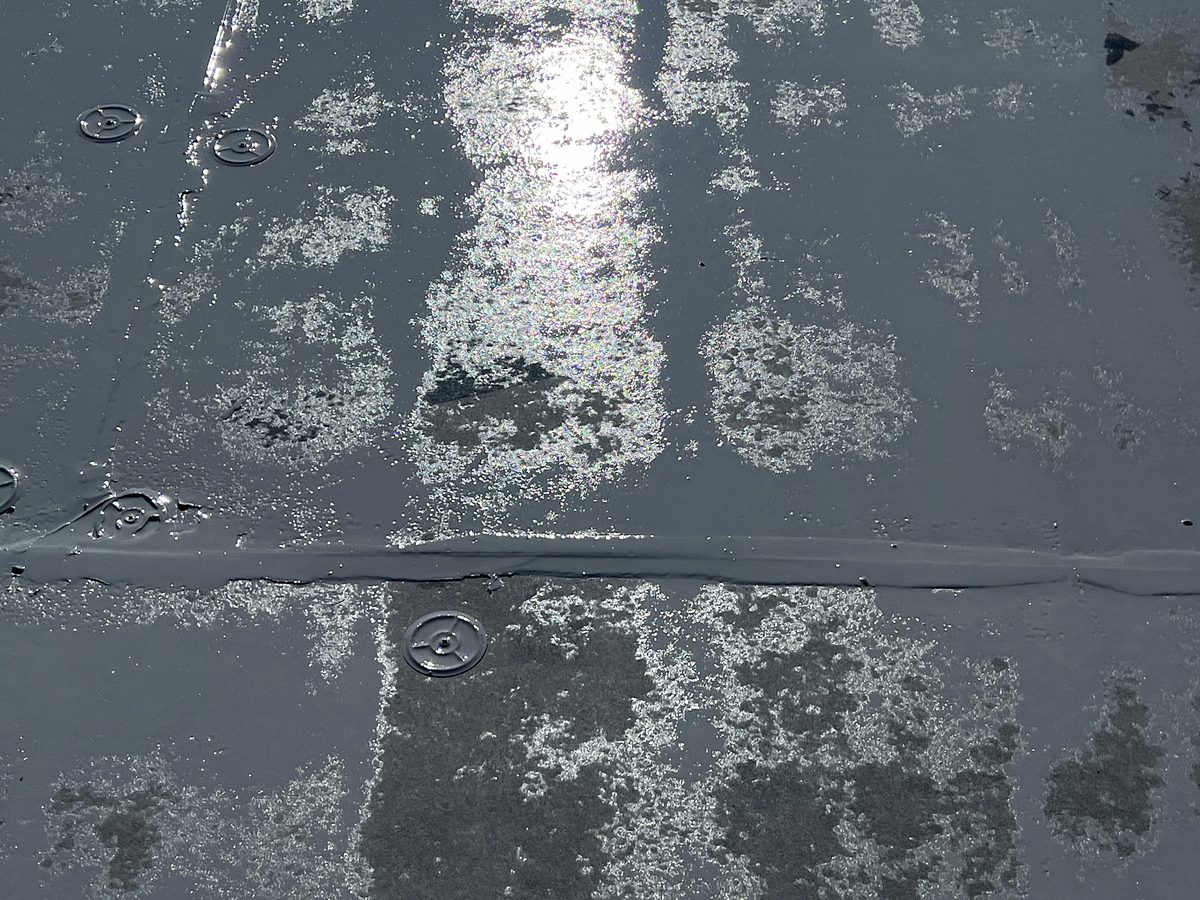 Before: aged roof surface with worn coating and exposed fasteners